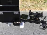 Overall lot showing machine, case, attachment box and plastic bag