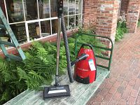 Full view of Samsung Quiet Storm vacuum cleaner with hose, metal wand, and floor head.