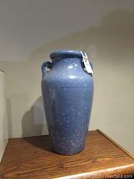 Photo of blue stoneware urn showing full front angle and size scale