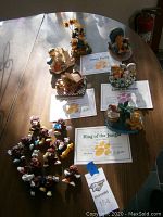 Overview of assorted Garfield ceramic collectibles with certificates, and a group of California Raisin figurines.