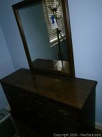 Image of Bassett wooden dresser with large rectangular mirror attached, showing wood finish and overall condition