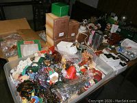 Wide shot showing multiple storage bins and boxes filled with various Christmas decorations.
