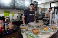 Image showing the restaurant counter with baked goods and staff behind counter, showcasing the establishment environment.