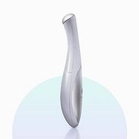 Silver ergonomic handheld Opatra DermiEye device for reducing eye puffiness and bags.