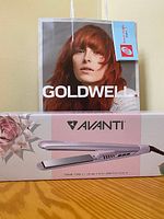 Photo of boxed Avanti titanium hair straightener showing product image, brand, and model description.