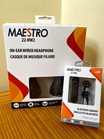 Front view of packaging for MAESTRO 22-HW2 on-ear wired headphones and 22-HBB Bluetooth earbuds showing branding and product types.
