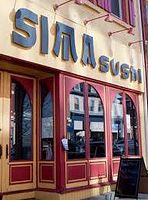 Exterior sign of Sima Sushi restaurant showing storefront and signage.
