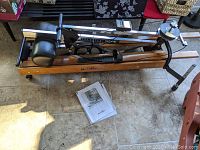 Original NordicTrack exercise machine with instruction manual on the floor beside it.