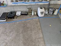 Wide view showing various countertop appliances on floor and low shelf