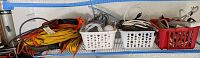 Shelves with extension cords and various cables organized in baskets