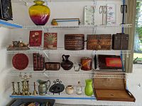 Wide view of wire shelves with various decor items including vases, boxes, plates, and other decorative objects