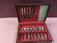 View of entire set in box including all utensils in layout.