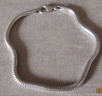 Top view of the sterling silver snake design bracelet showing the lobster clasp and chain detail.