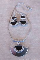 View of sterling silver necklace and earrings set with black onyx accents, showing Deco style design with beadwork