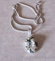 Full view of the pendant and chain showing the Ocean Jasper stone with silver wire detailing on front