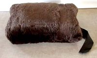 Front view of the brown sheared beaver fur muff lying flat, showing texture and color of the fur.