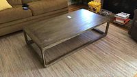 Top-down side angle view of weathered wooden coffee table showing dimensions and frame style.