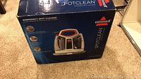 Box showing front view of the Bissell SpotClean with branding and product image.