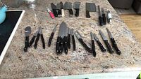 Overview of all knives and accessories arranged on countertop