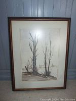 Framed watercolor artwork showing three birch trees and wooden fence.