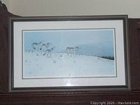 Framed limited edition print 'The Howling Wolf Pack' featuring wolves in a snow landscape, signed and numbered by artist J. Filipchuck. Frame has a small nick.