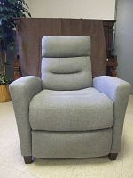 Front view of grey fabric recliner chair in upright position showing cushioned back and armrests.