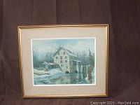 Front view of framed reproduction painting titled 'Wentworth Mill' showing the mill building in winter with snow and water.