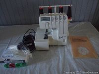 Front view of Brother overlock machine with accessories on table
