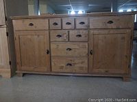 Front view of pine buffet sideboard showing drawers and cabinet doors