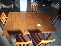 Wide shot of teak dining table with five chairs
