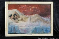 Front view of framed oil painting on canvas by A. Calio depicting reclining nude figure draped in white cloth