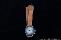 Front view of watch showing leather strap, rotating bezel and dial