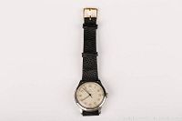 Full view of watch face and black leather strap