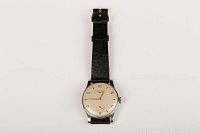 Front view of watch showing silver dial, Arabic numerals, and black lizard strap.