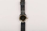 Front view of the watch showing the dial and fabric strap.