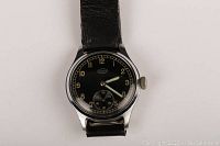 Front view of watch showing black dial, luminous hands, Arabic numerals, subsidiary seconds dial and Onda logo