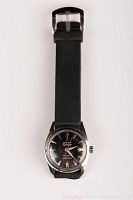 Front view of watch with black strap on white background