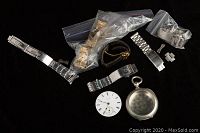 Overview group shot on black background showing pocket watch case, separate dial, and various watch straps and bracelets