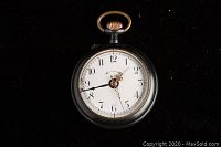 Front view showing white dial, Arabic numerals, gold-tone hands, and black case with gold-tone crown and bow