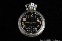 Front view of dial showing luminous Arabic numerals and subsidiary seconds dial