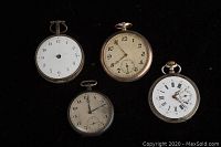 Four silver pocket watches arranged on black background showing dial faces and conditions
