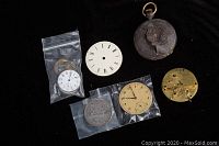 Showing entire lot including watch parts, cases, and 1935 Canadian silver dollar coin
