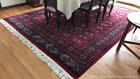 Full view of red wool rug under dining table