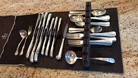 Overview of all flatware pieces arranged on roll