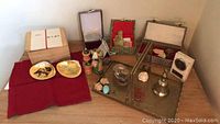 Overview of lot on red cloth and brass tray with shells, boxes, jade pieces, seals, stone, bell, Buddha