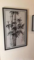 Frontal view of framed bamboo painting on wall