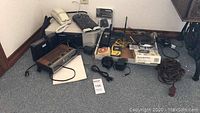 Full lot with radios, phones, safe, power strip, cables on floor