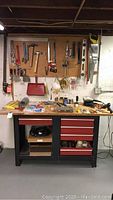 Full front view of bench with pegboard and tools mounted