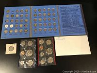Overview photo showing blue folder style coin holder with multiple Mercury dimes slots, two sealed 1981 uncirculated coin sets (blue and red bordered), and one 1911 Mercury Head dime in holder.