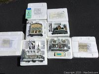 Four Thomas Kinkade Hawthorne Village buildings nestled in Styrofoam packaging with certificates visible.